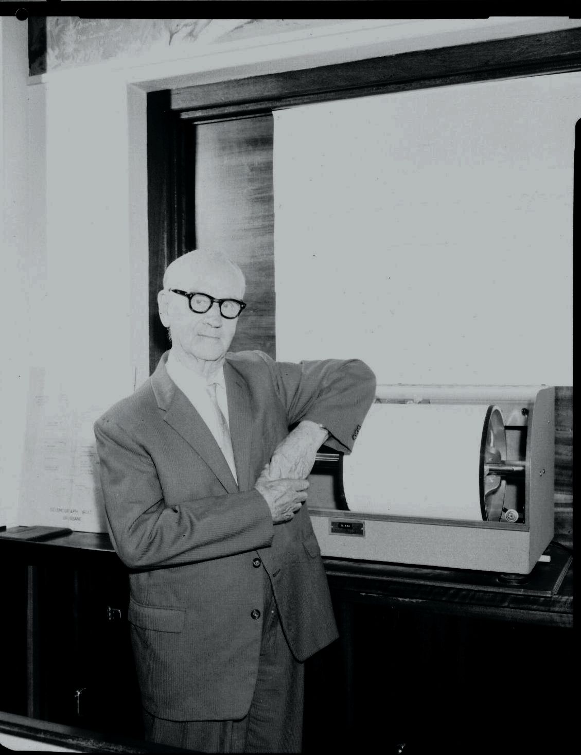 WH Bryan MC beside the seismograph that used to be in University of Queensland’s original museum on the ground floor of the Richards Building.